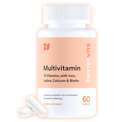 Multivitamin supplement bottle with white capsules on a light pink background